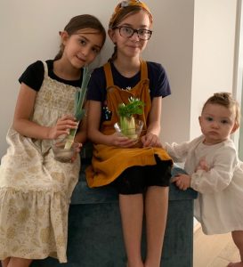 Children holding day 28 plants